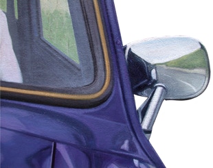 detail of the road reflected in the wing mirror